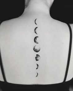 the back of a woman's neck with phases on it