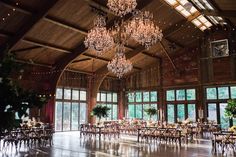 a large room with chandeliers and tables in it