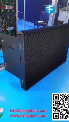 the back side of a computer case on display in a room with blue flooring