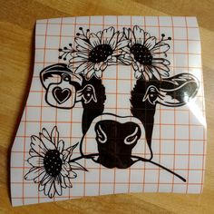 a cow with sunflowers on it's face is painted on a piece of paper