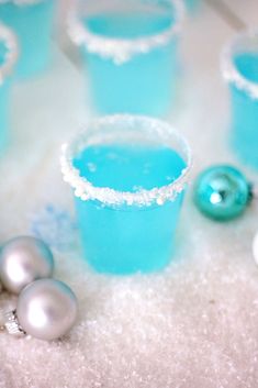 blue glasses filled with liquid and silver ornaments