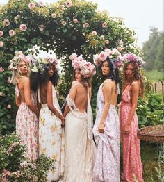 the models are all dressed up in dresses and flower crowns, with one woman standing next to her