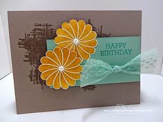 a close up of a card with flowers and a ribbon on the bottom of it