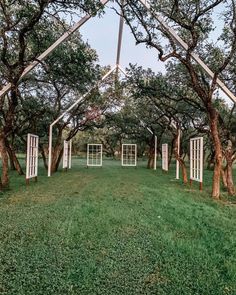 an outdoor ceremony setup with open doors and trees in the background, surrounded by lush green grass