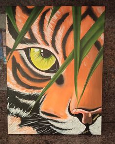 a painting of a tiger's face with green grass in the foreground and yellow eyes