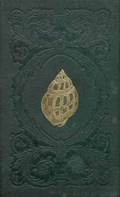 an old book with gold foil on the cover and green paper in the middle that says,