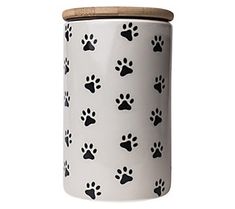 a white canister with black dog paw prints on the side and a wooden lid