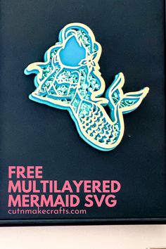 there is a blue and white sticker on the back of a black box that says free multilayered mermaid svg