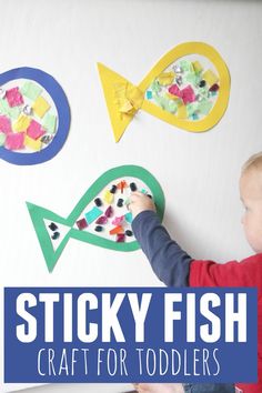 a young boy is working on some fish crafts