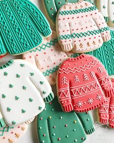 decorated cookies with sweaters and mittens on them are displayed in front of the camera