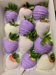 a box filled with purple and white strawberries