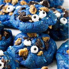 blue cookies with googly eyes and oreos on top, all decorated in white chocolate chips