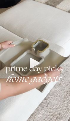 a woman is holding a tray on top of a couch with the words prime day picks home gadgets