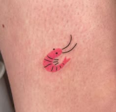 a small pink crab tattoo on the leg