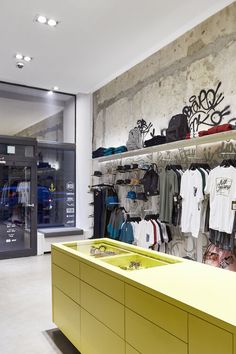 a clothing store with yellow counter and shelves