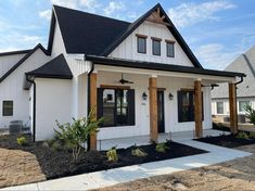 a white house with black roof and windows