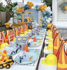 an outdoor party with construction themed tables and decorations