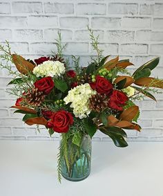 a vase filled with red and white flowers