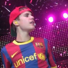 a young man standing in front of a stage with confetti