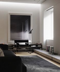 a living room filled with furniture and a book shelf in front of a large window