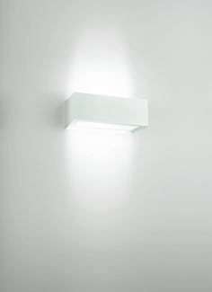 a white wall light mounted on the side of a wall