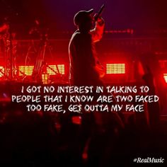 a person on stage with a microphone in front of him and the words i got no interest in taking to people that i know are two faced too far, get outa