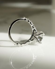 a diamond ring sitting on top of a table