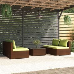 an outdoor living area with two couches and a table