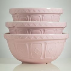 four pink bowls stacked on top of each other