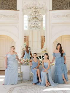 the bridesmaids are posing in their blue dresses