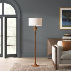 a living room scene with focus on the floor lamp