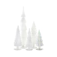 white plastic christmas trees are lined up against a white background