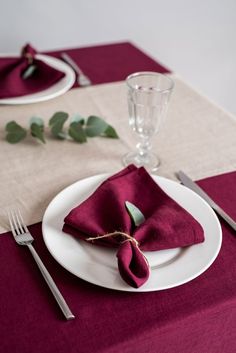 a place setting with napkins and silverware