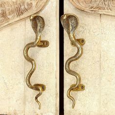 an ornate door handle with a snake design on the front and back side of it