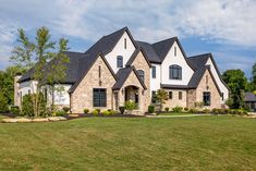 a large house with lots of windows in the front yard