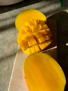 a sliced mango sitting on top of a cutting board