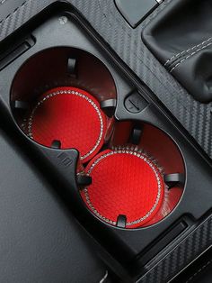 two red buttons in the center console of a car