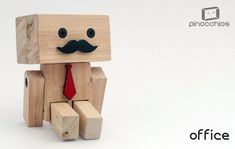 a wooden toy with a red tie and mustache on it's head, sitting in front of a white background