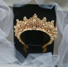 This pearl gold tiara has a luxurious gold color and excellent shine. Tiara is made of the finest materials: crystal beads, pearl beads, rhinestones, metal elements and gold wire.In the photo a crown in decoration: gold + ivory pearls.Crown height in center: Approx. 2.35" (6 cm).Length of earrings: Approx. 1.35" (3.5 cm).______________________________________________________________• All orders from the Exclusive Wedding Shop you will receive in a FREE beautiful gift box.• Here is an approximate Gold Wedding Crown Tiaras, Gold Princess Crown For Wedding, Regal Gold Crown For Wedding, Gold Crown Headpiece With Rhinestones, Pearl Tiara Wedding, Crystal Crown Tiaras Gold, Bridal Crown Crystal, Gold Bridal Crowns, Quinceanera Tiaras