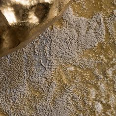 a close up view of an area rug with dirt on it