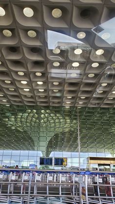 the inside of an airport with lots of lights on it's ceiling and windows