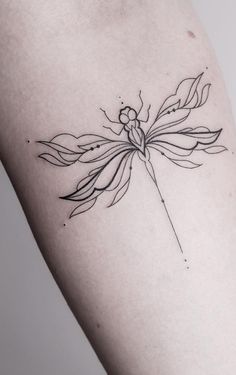 a woman's arm with a small tattoo on the back of her body, depicting a flower