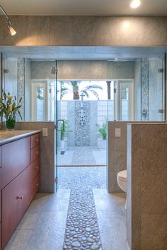 a bathroom with a sink, toilet and shower stall in it's own area