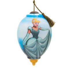 a glass ornament with a woman wearing a blue dress and holding a tassel