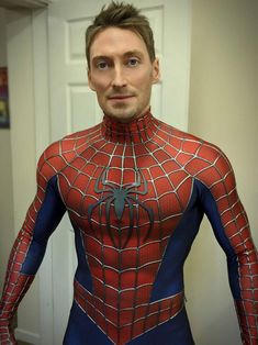 a man in a spider - man costume poses for the camera