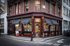 an old fashioned store on the corner of a city street