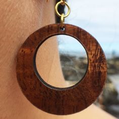 Presenting our Hoop koa wood earrings design. The Hoops design is handcrafted from the finest reclaimed Hawaiian koa hardwood, grown and milled on the Big Island of Hawaii. The Hoop measures approximately 1 1/4 inches in height and finished with gold-filled findings. Brown Small Hoop Earrings With Ear Wire, Brown Hoop Jewelry With Ear Wire, Brown Single Hoop Earring, Brown Hoop Single Earring, Brown Wooden Round Earrings, Handmade Wooden Round Earrings, Handmade Round Wooden Earrings, Handmade Round Wooden Jewelry, Round Brown Wooden Jewelry