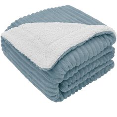 the blue and white blanket is folded on top of each other, with two different colors