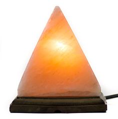 a light that is sitting on top of a wooden stand with a cord attached to it