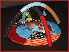 a baby laying on top of a play mat